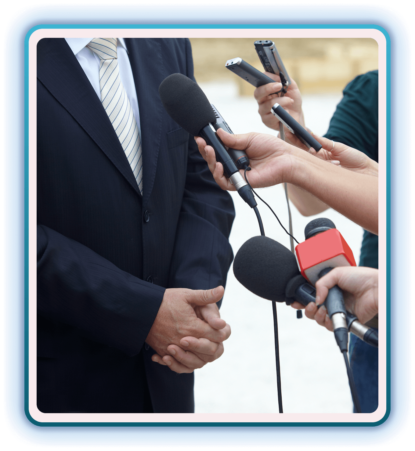 Man in suit facing reporters